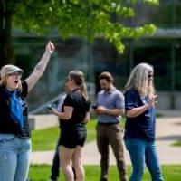 Abby McClure raises her hands in celebration after throwing her bag